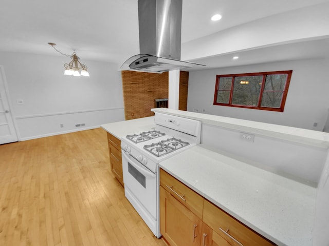 kitchen with island range hood, light hardwood / wood-style floors, and white gas range oven