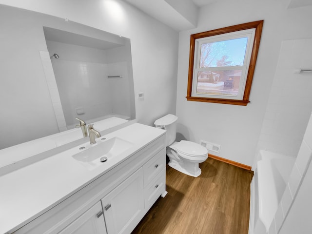 full bathroom with wood-type flooring, vanity, toilet, and shower / washtub combination