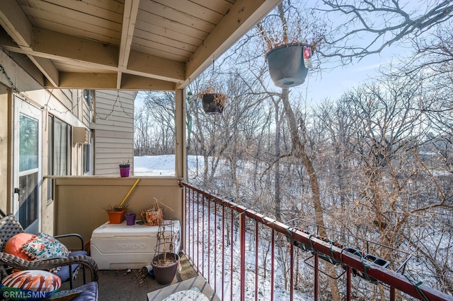 view of snow covered back of property