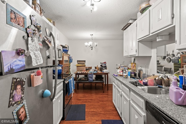 kitchen featuring appliances with stainless steel finishes, an inviting chandelier, decorative light fixtures, dark hardwood / wood-style flooring, and white cabinets