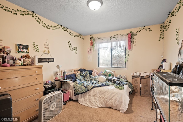 bedroom featuring light carpet and a textured ceiling