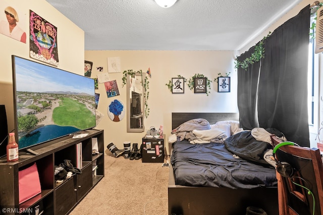 bedroom featuring a textured ceiling and light carpet