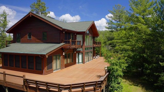 rear view of property featuring a wooden deck