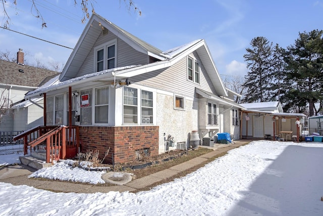 snow covered property with a storage shed