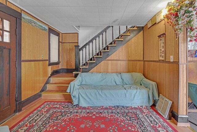 foyer entrance featuring light hardwood / wood-style flooring and wooden walls