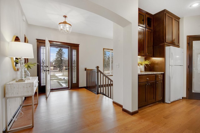 entrance foyer with a chandelier and light wood-type flooring