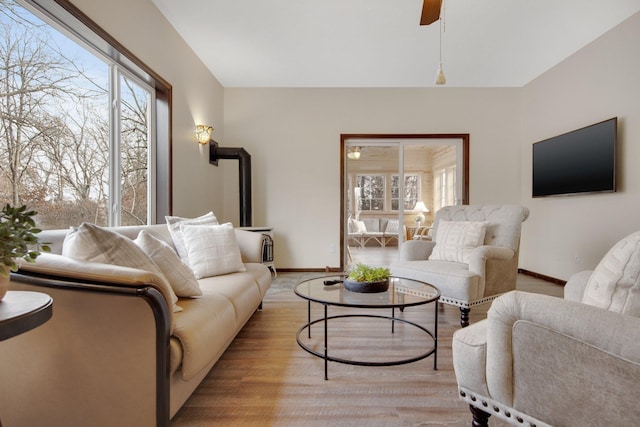 living room with ceiling fan and light hardwood / wood-style floors