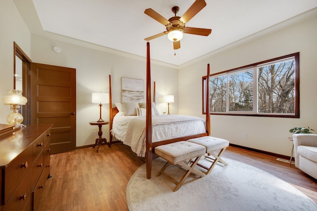 bedroom featuring ceiling fan, wood-type flooring, and crown molding