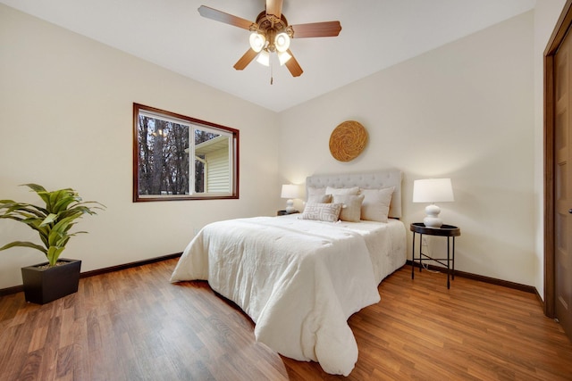 bedroom with hardwood / wood-style floors and ceiling fan