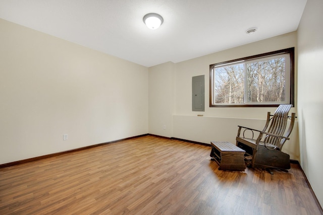 unfurnished room with hardwood / wood-style floors and electric panel