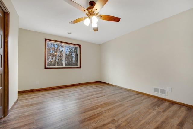 empty room with ceiling fan and light wood-type flooring