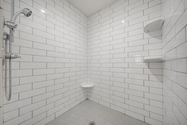 bathroom with tiled shower