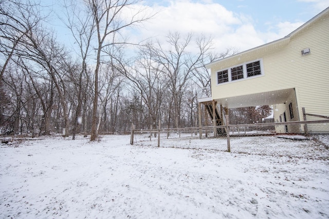 snowy yard with a carport