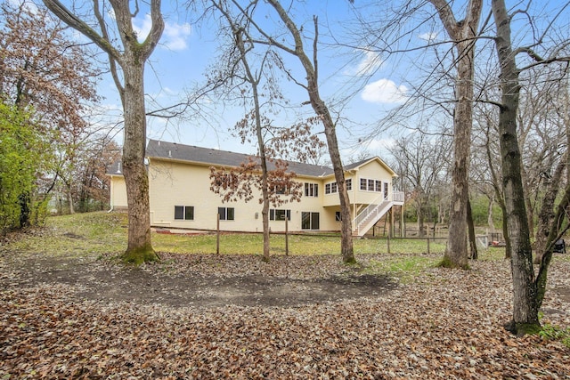 back of house featuring a yard and a wooden deck