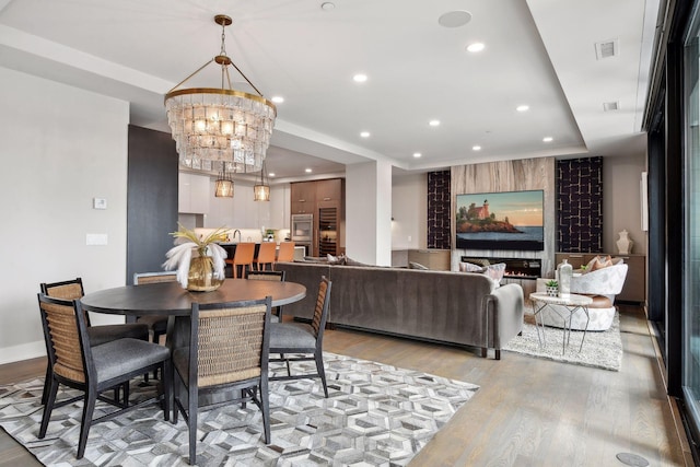 dining area featuring a notable chandelier and light hardwood / wood-style floors