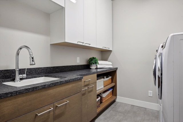 interior space with washer and dryer, sink, and cabinets