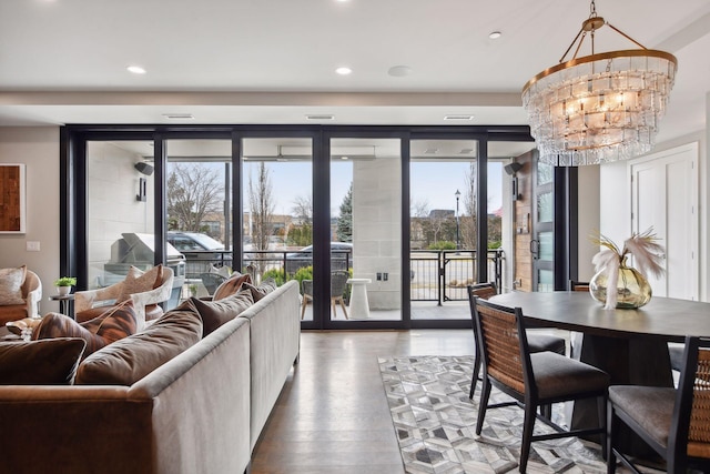 living room featuring wood-type flooring and a chandelier