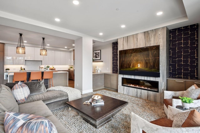 living room featuring a large fireplace