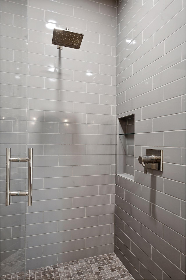 bathroom featuring a shower with shower door