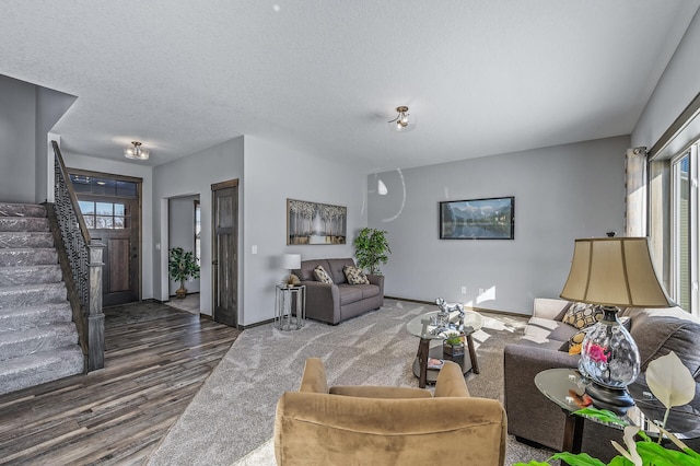 living room featuring dark wood-type flooring and a textured ceiling