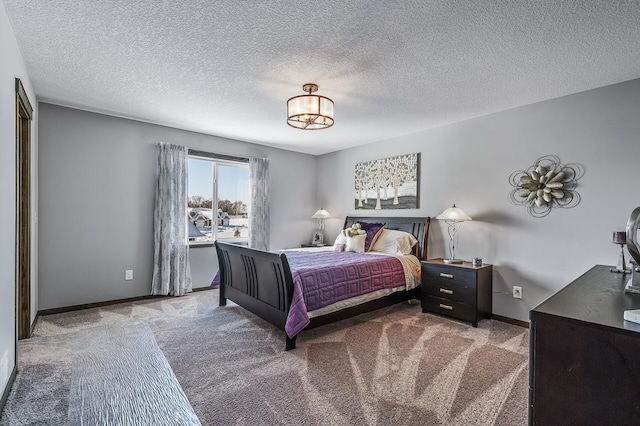 bedroom with carpet floors and a textured ceiling