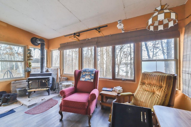 sunroom featuring a wood stove