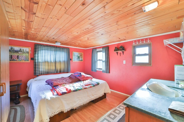 bedroom with sink, ornamental molding, wooden ceiling, and hardwood / wood-style flooring