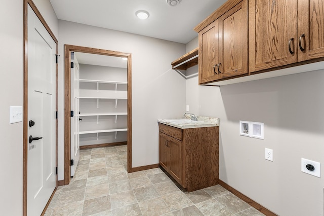 laundry room with cabinets, light tile patterned floors, electric dryer hookup, and washer hookup