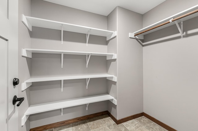 spacious closet with light tile patterned floors