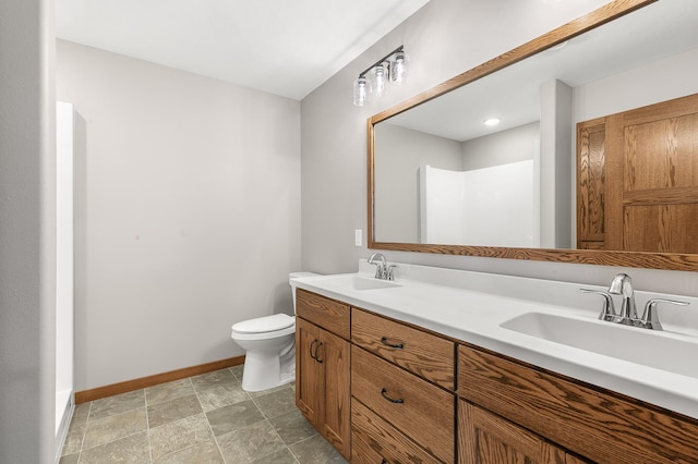 bathroom with double vanity, tile patterned flooring, and toilet