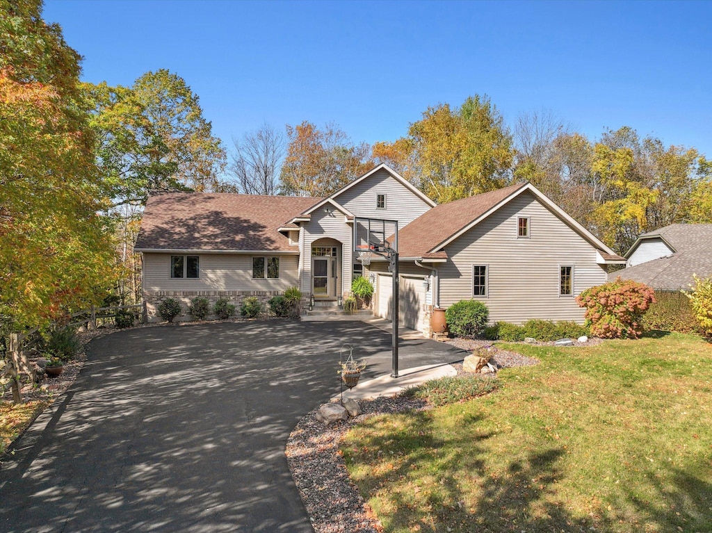 view of front of house with a garage and a front lawn