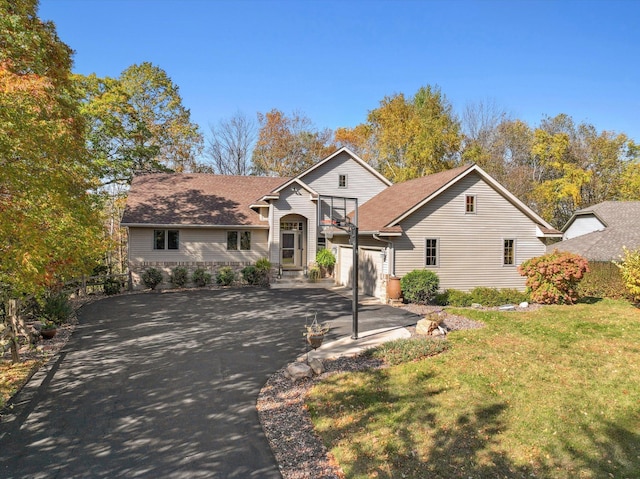 view of front of house with a garage and a front lawn