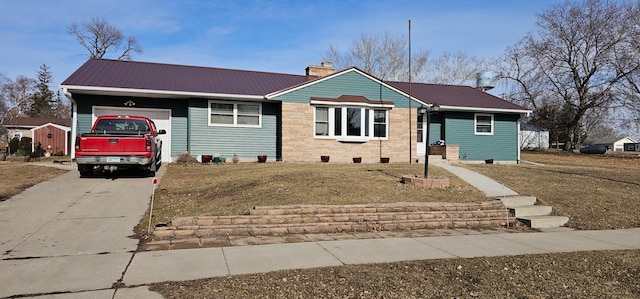 ranch-style house with a chimney, driveway, metal roof, and a garage