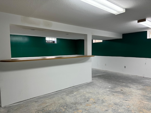 below grade area with a textured ceiling