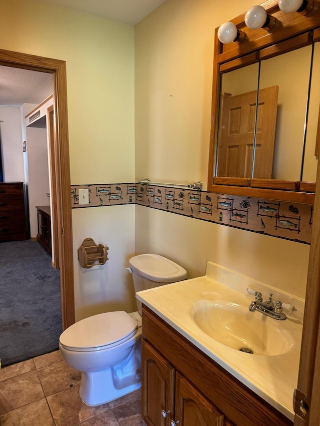 bathroom featuring toilet and vanity