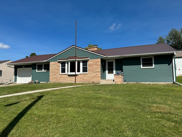 single story home with metal roof, a front lawn, and an attached garage