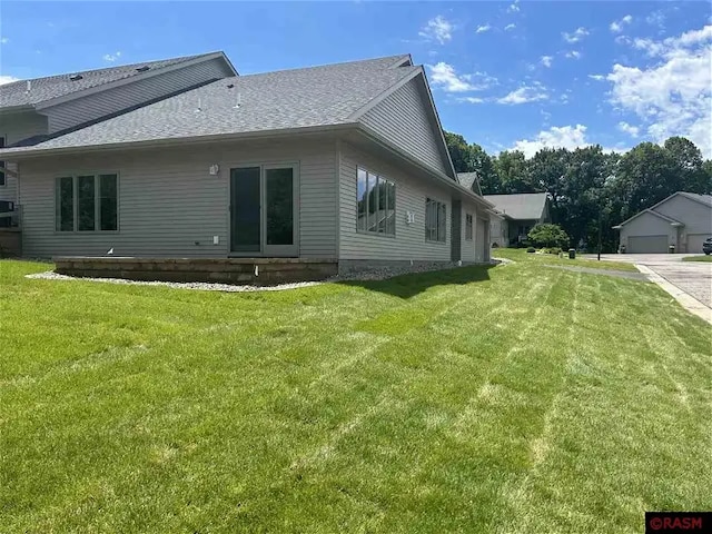 view of side of property with a yard