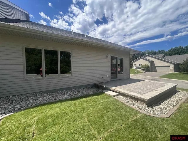 rear view of house featuring a yard and a patio