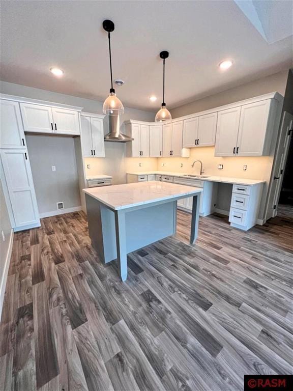 kitchen featuring wall chimney range hood, white cabinets, and dark hardwood / wood-style floors