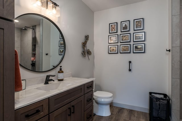 bathroom featuring toilet, wood-type flooring, and vanity