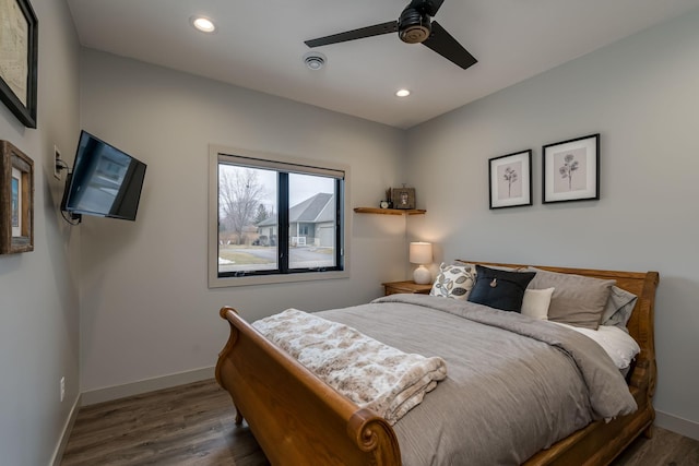 bedroom featuring ceiling fan and dark wood-type flooring