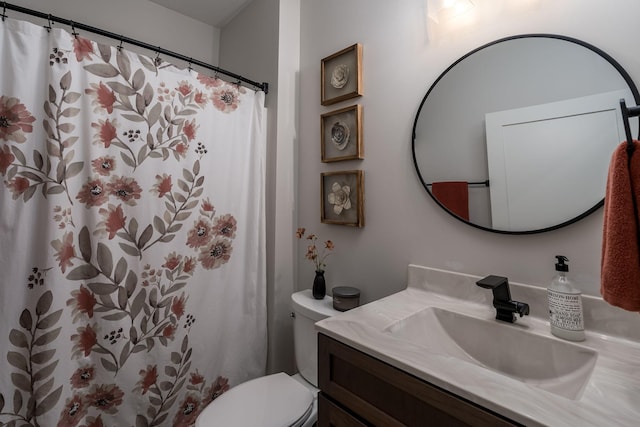 bathroom featuring toilet, vanity, and curtained shower