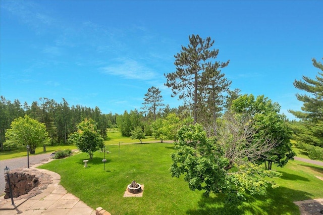 view of home's community featuring a fire pit and a lawn