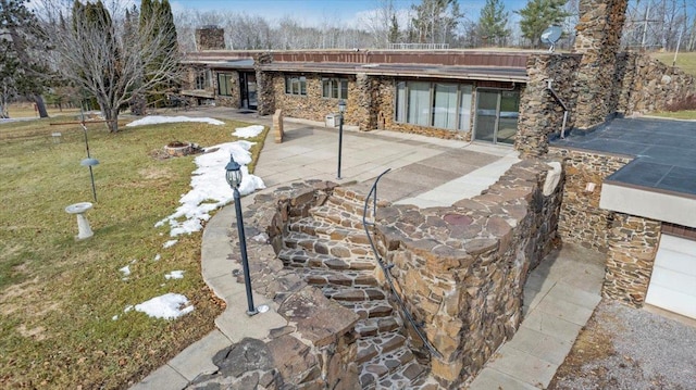 rear view of house with a yard and a patio