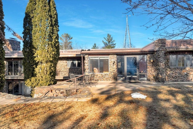 rear view of property featuring a lawn and a patio area