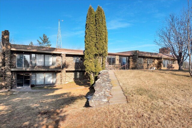 rear view of house with a yard