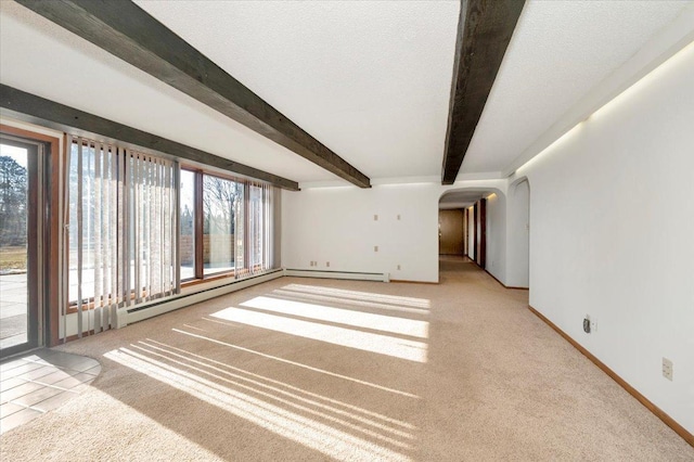 unfurnished living room with beamed ceiling, baseboard heating, light carpet, and a textured ceiling