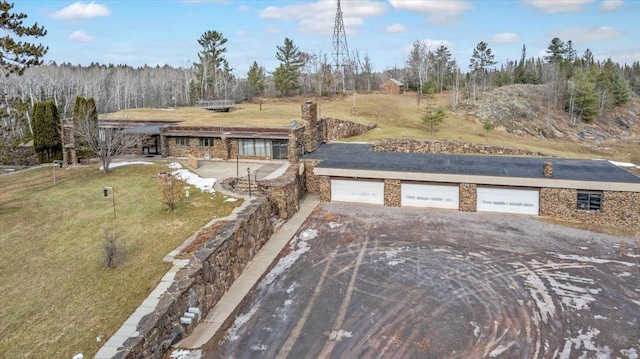 view of front of property with a garage and a front lawn