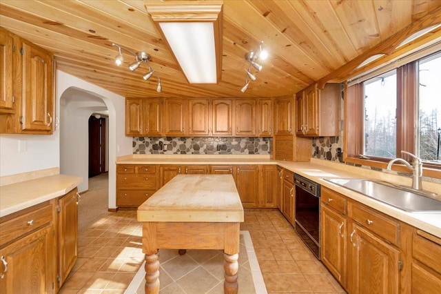 kitchen featuring sink, wood ceiling, dishwasher, backsplash, and light tile patterned flooring