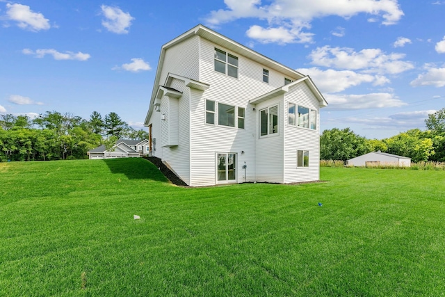 rear view of property with a lawn